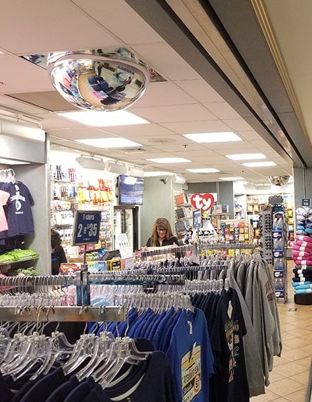 Full dome security mirror in retail shop shows how added security can easily be added to the ceiling.