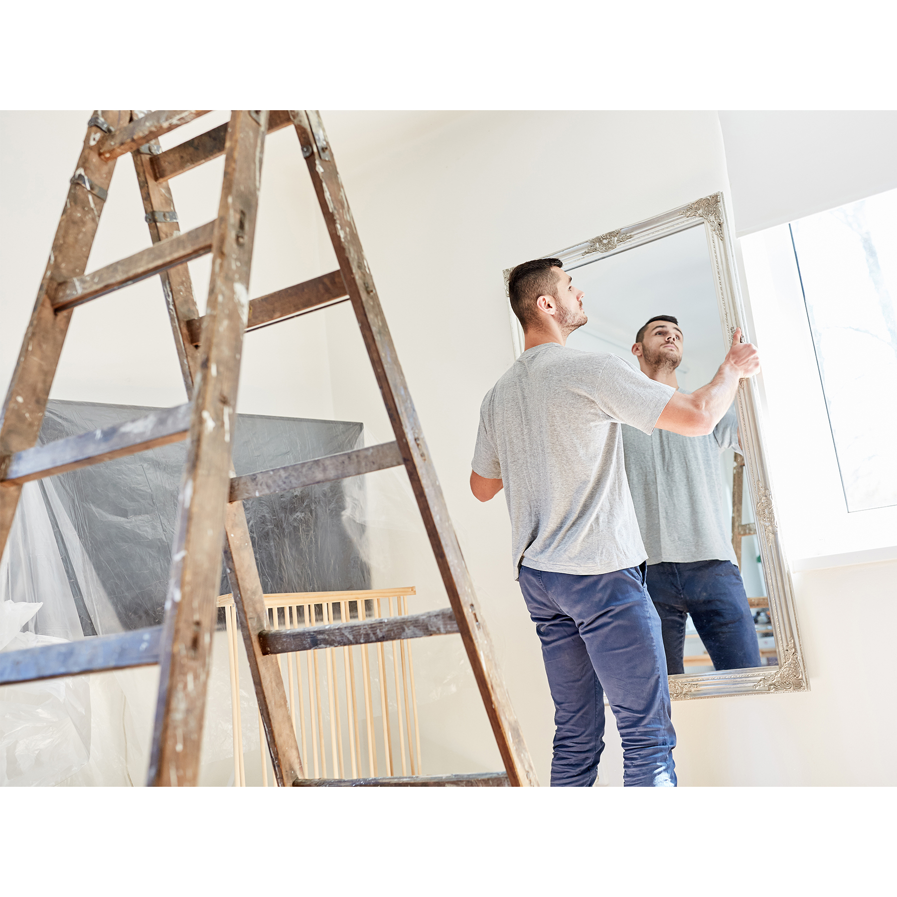 Man-Hanging-A-Custom-Mirror