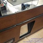 Acrylic two way mirror in checkout lane of grocery store allows the cashier to discreetly observe the shopping cart for items. Shoppers assume they are being recorded through the mirror, which prevents shoplifting. Two way mirror hidden camera in grocery store
